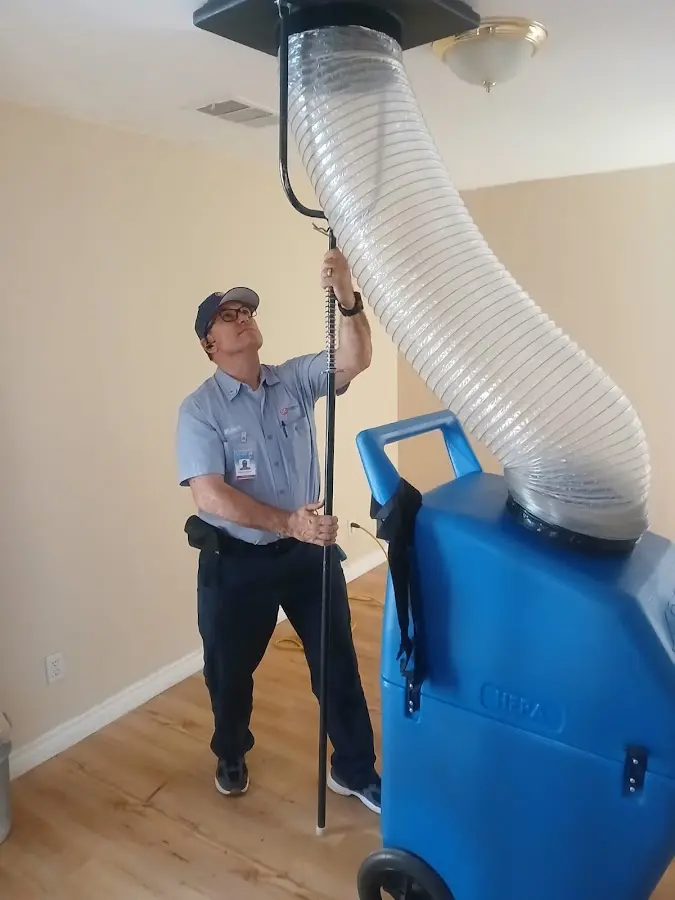 Furnace Tune-Up technician using HEPA equipment in Longview